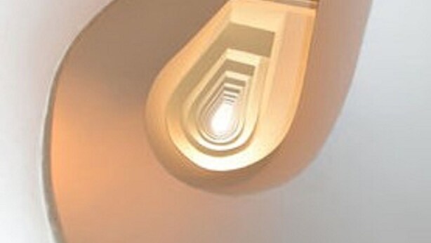 Una escalera de caracol con una lámpara en el centro.