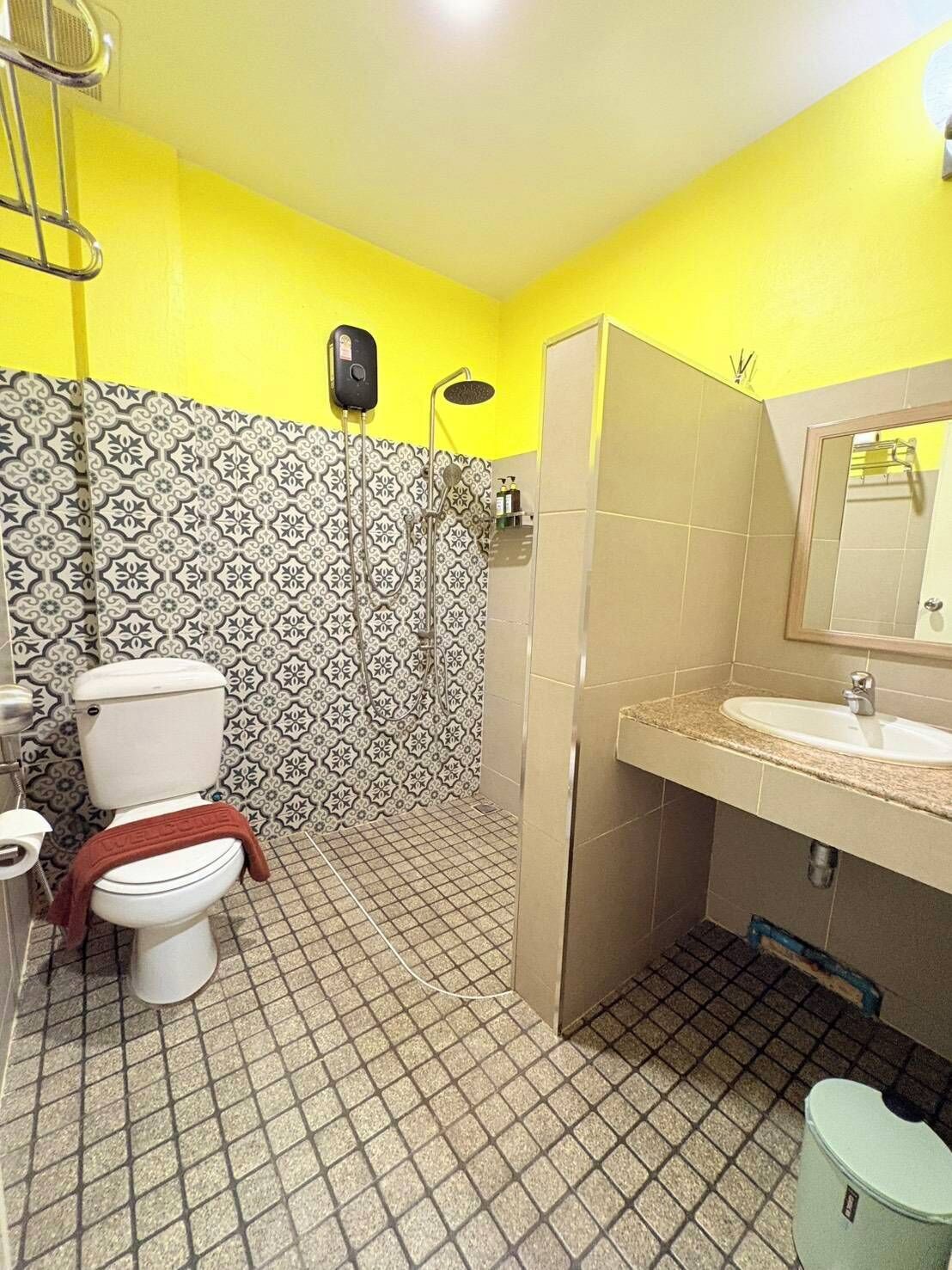 A bathroom with a toilet, sink, and shower.