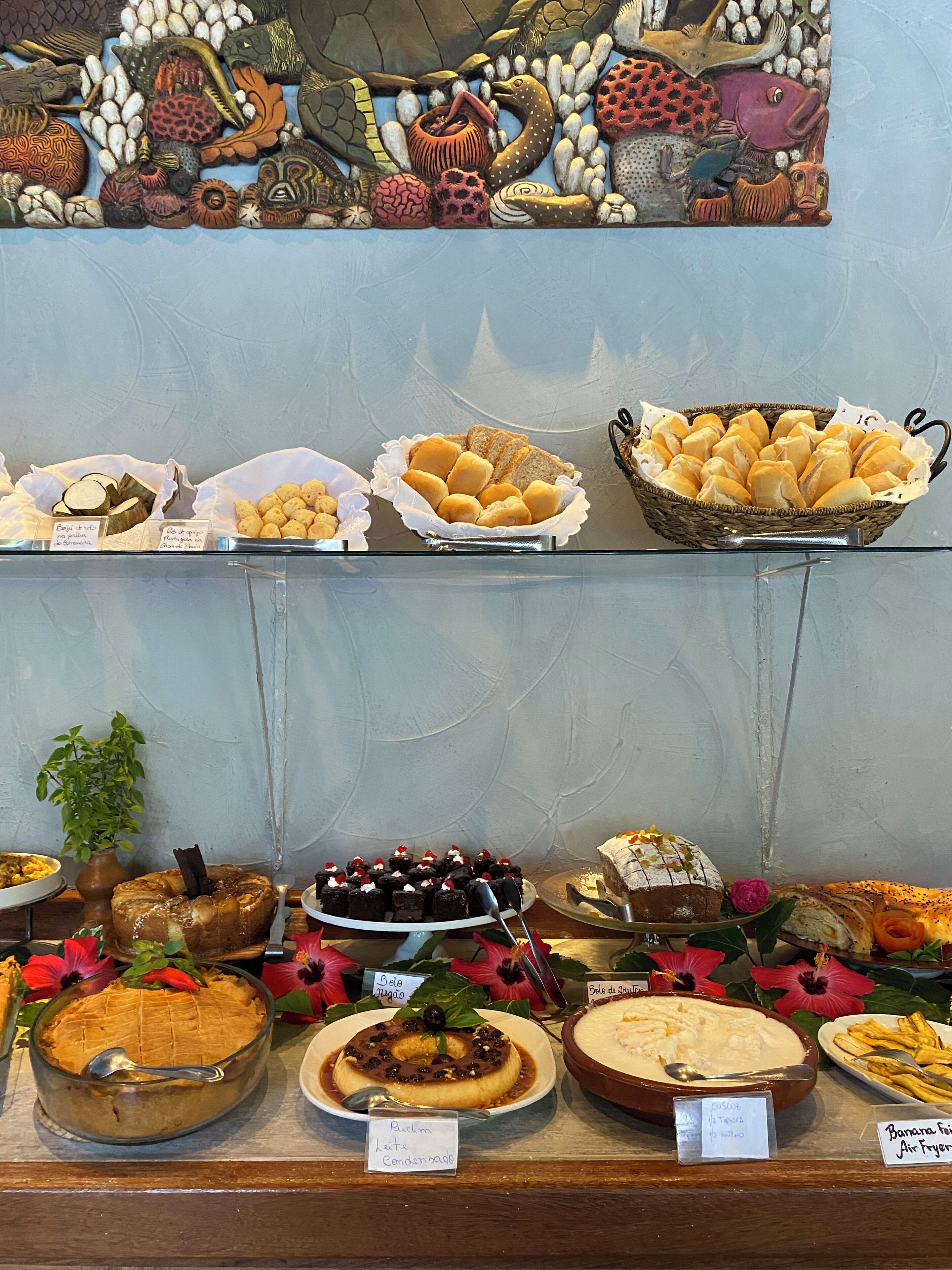 A buffet with various food items including bread, pastries, and desserts.