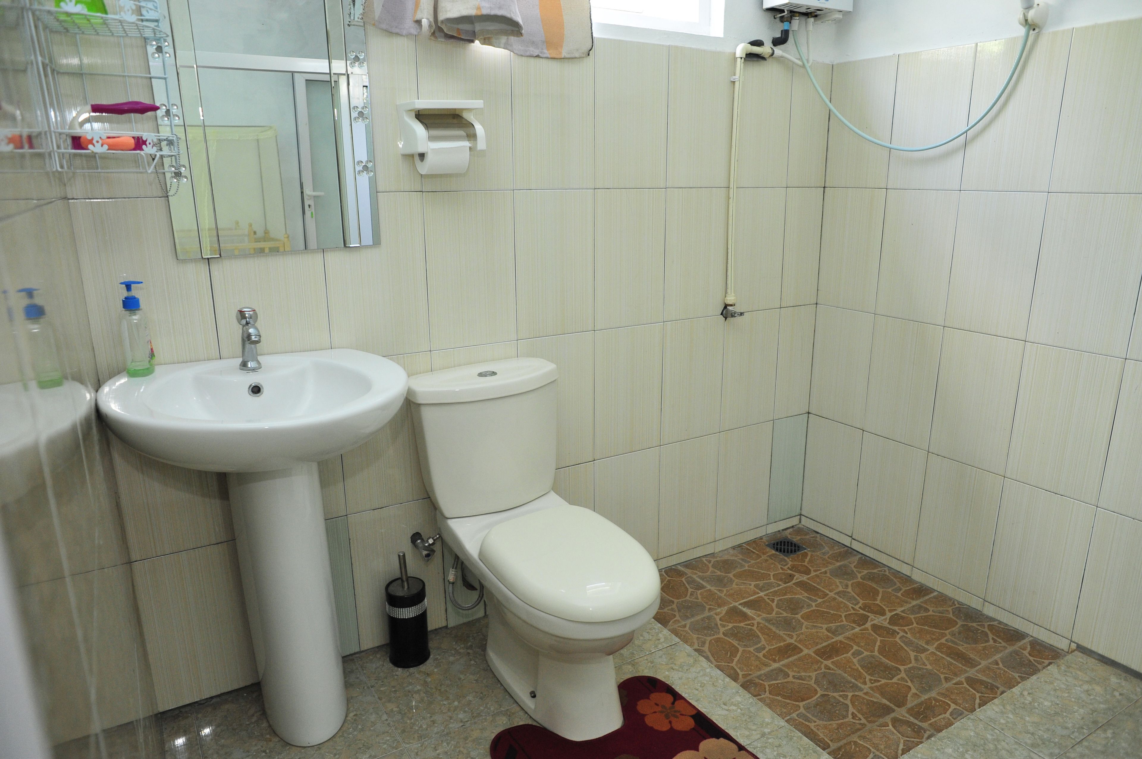 A bathroom with a sink, toilet, and shower.