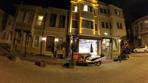 A multi-story building with a ground-floor shop and a parked scooter. - Meydan Suites (Istanbul)