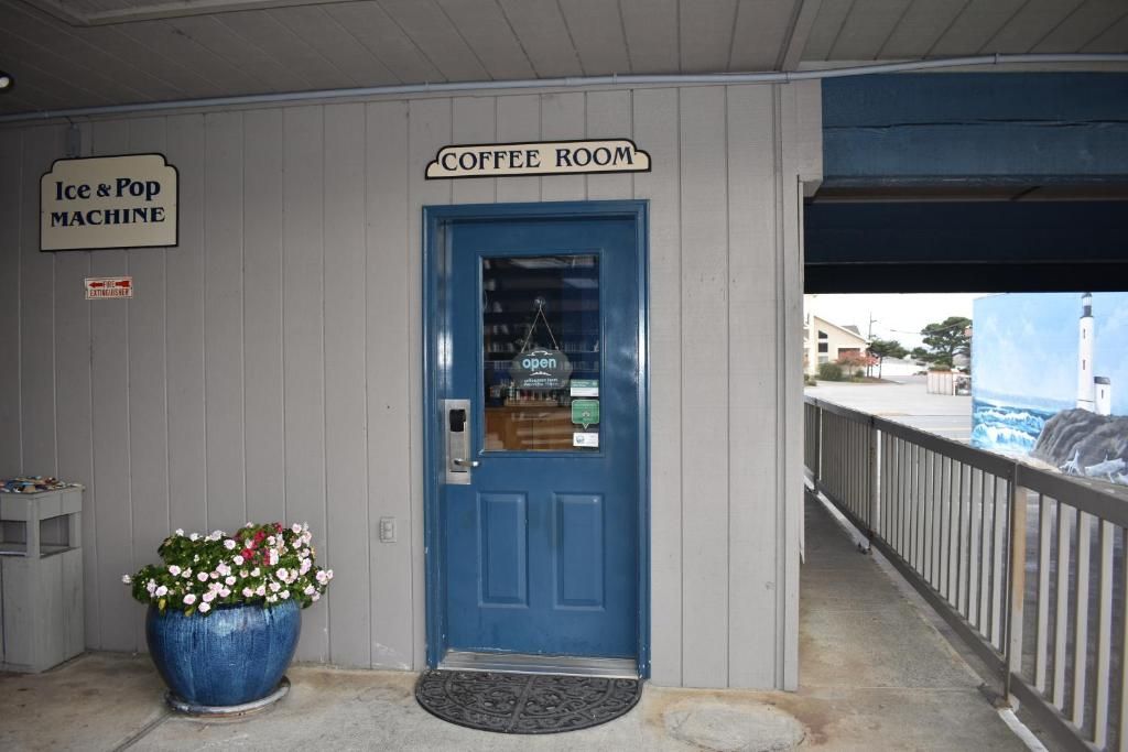 A blue door labeled 'Coffee Room' with a sign above it.