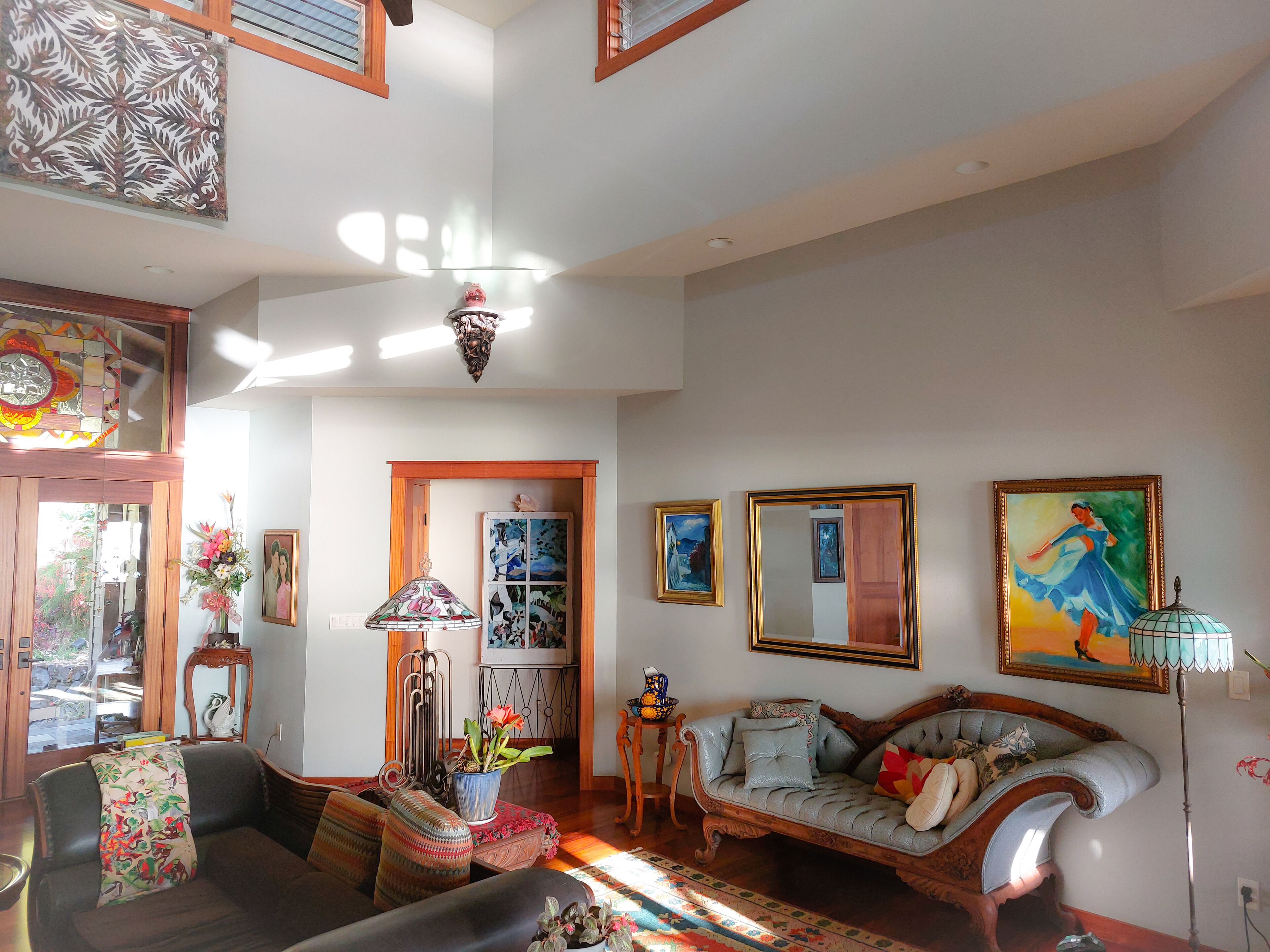 A spacious living room with a sofa, a coffee table, and a dining area.