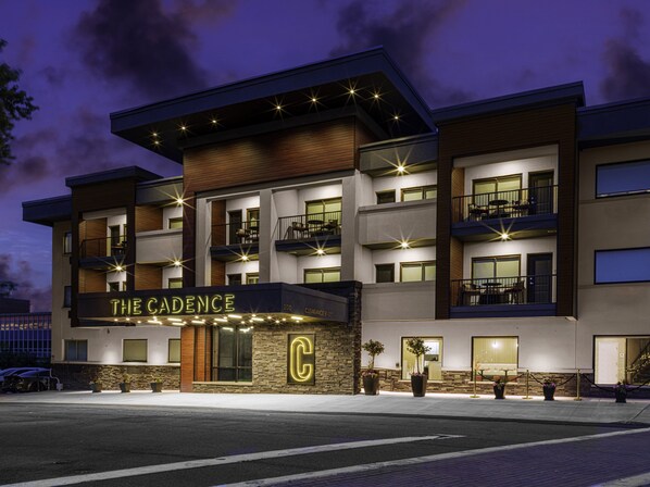 A multi-story hotel with a prominent 'C' logo on the facade, multiple balconies, and a well-lit entrance.