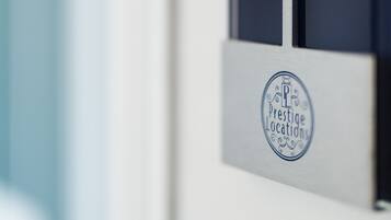 A door handle with a sign that reads "Prestige Locations."