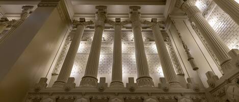 A grand architectural interior with ornate columns and detailed carvings.