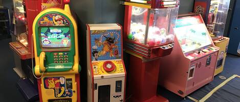 A row of arcade machines in a room with a blue carpet.
