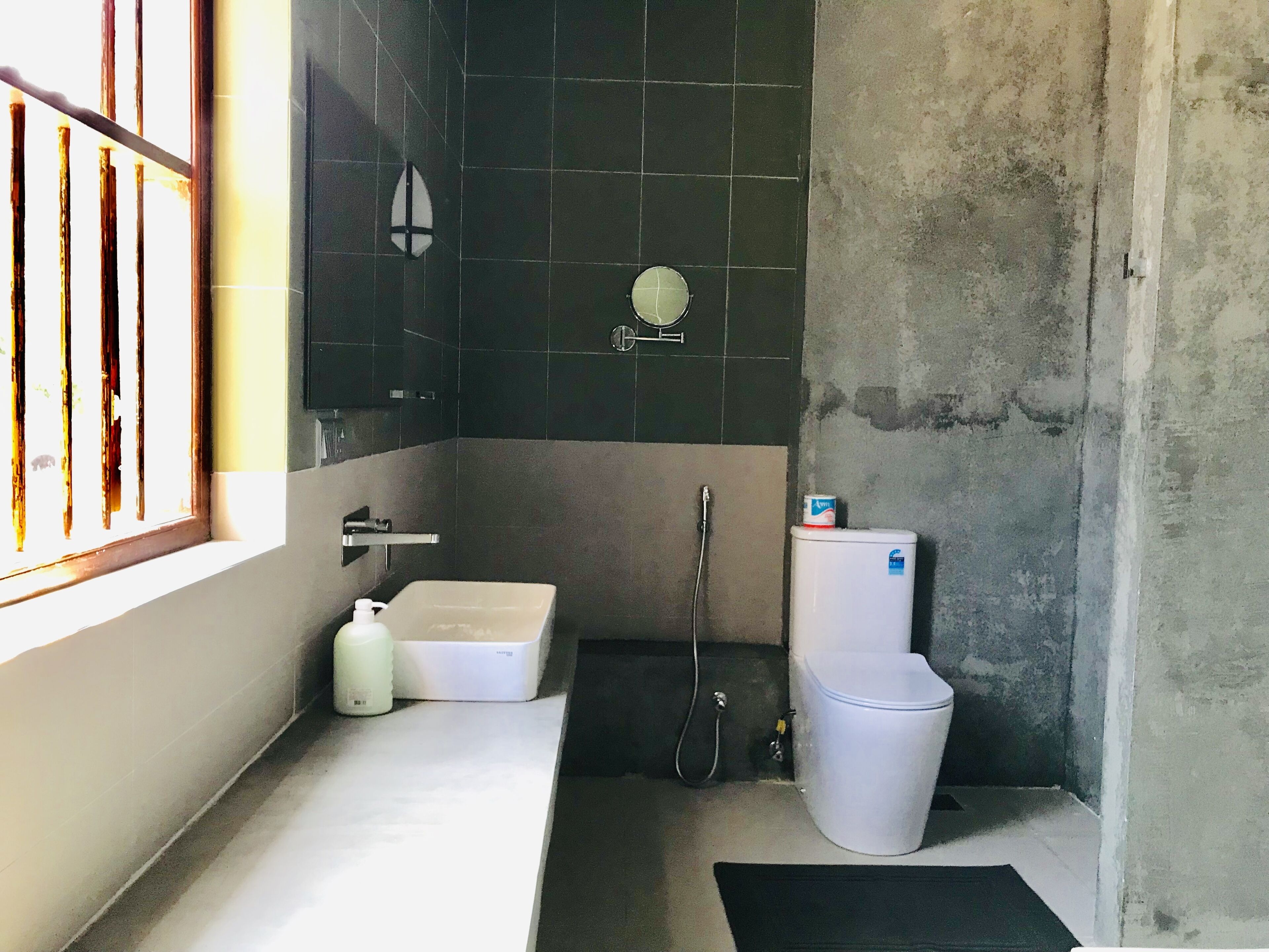 A bathroom with a bathtub, toilet, and sink.