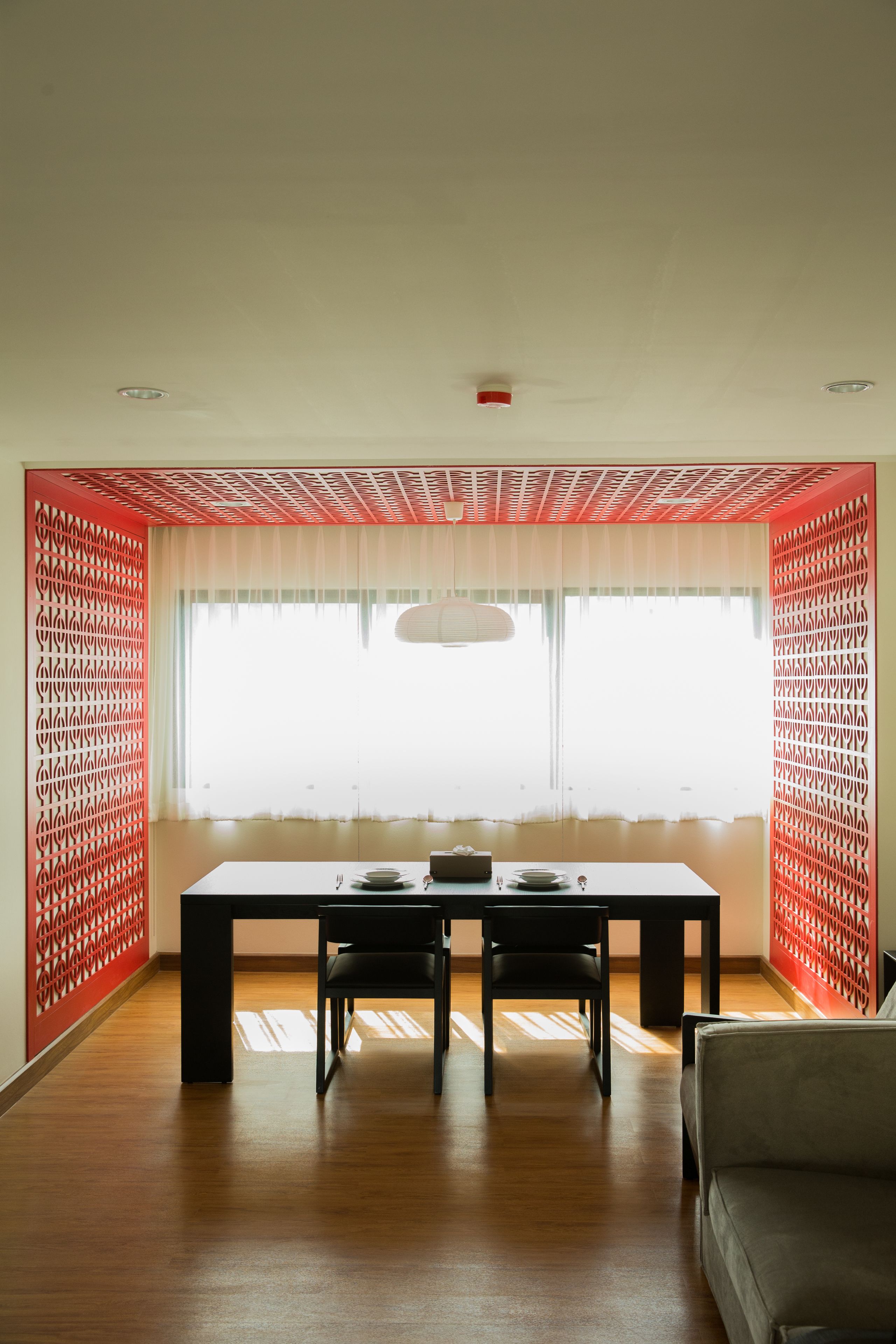 A dining area with a table, chairs, and a sofa.
