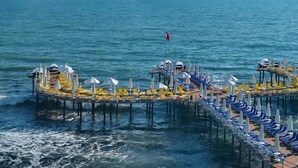 A circular pier with rows of sun loungers and umbrellas, extending into the sea. - Vikingen Infinity Resort & Spa - All Inclusive (Alanya)