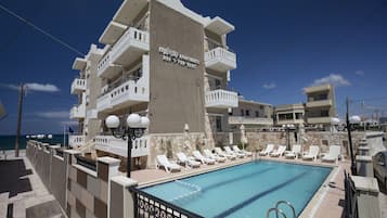Seasonal outdoor pool, pool umbrellas, pool loungers