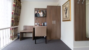 A room with a desk, chair, wardrobe, television, and a framed picture on the wall. - Hotel Park Plantage (Amsterdam)