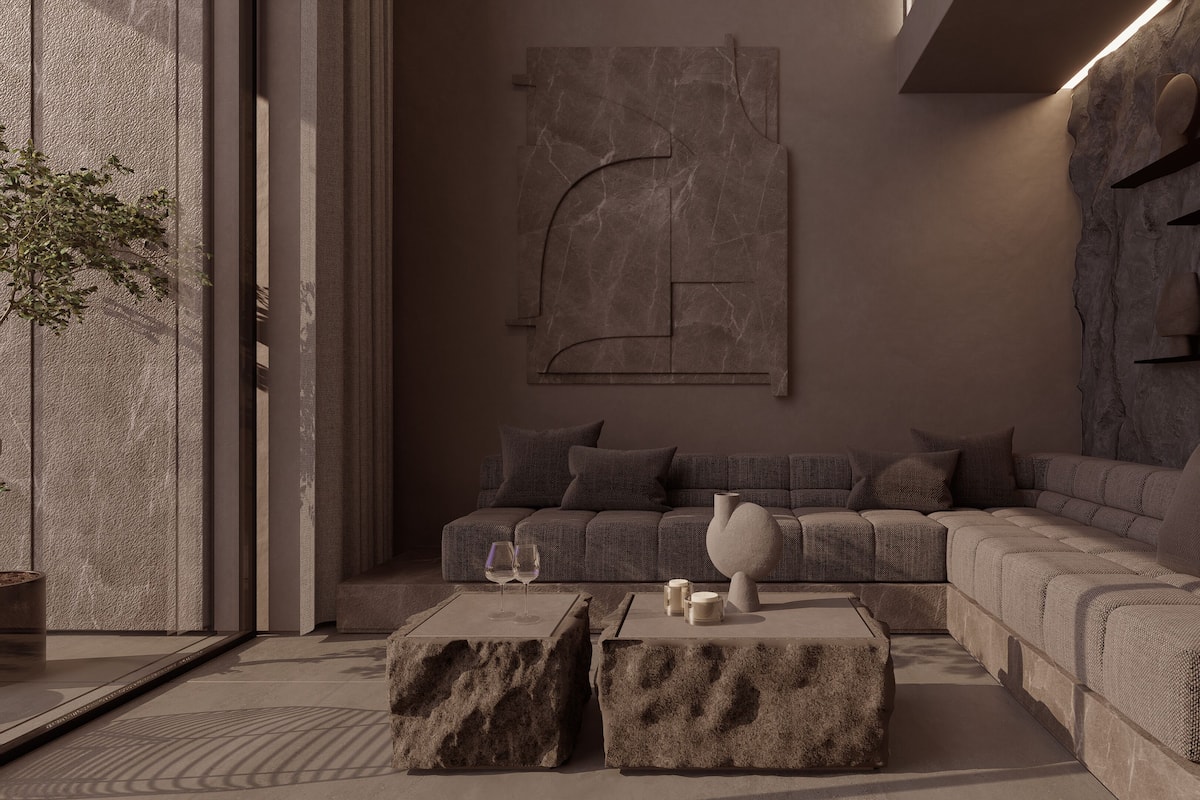 A modern living room with a sectional sofa, a coffee table, and a wall-mounted sculpture.