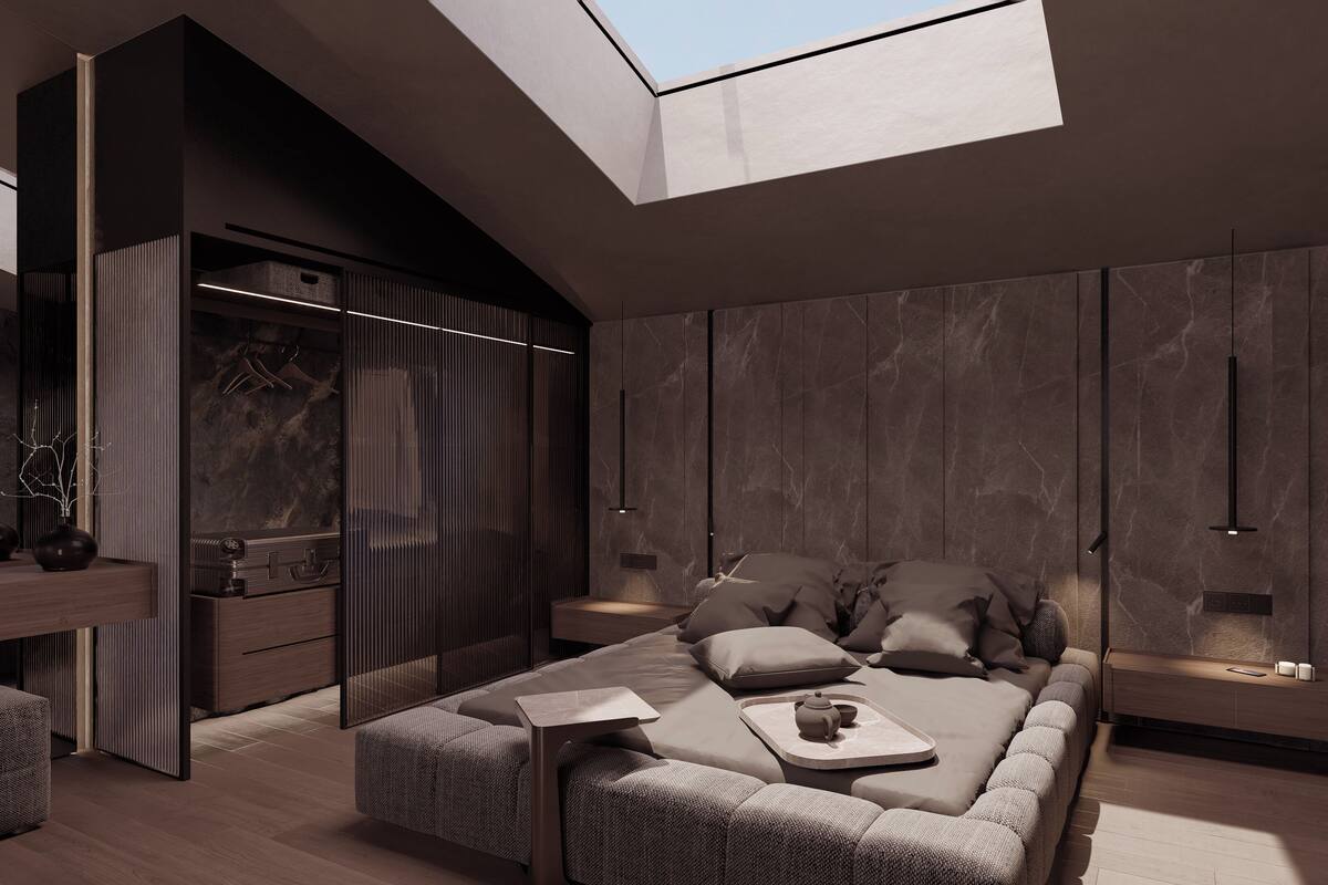 A modern interior with a skylight, a sofa with cushions, a small table, and a hanging light fixture.