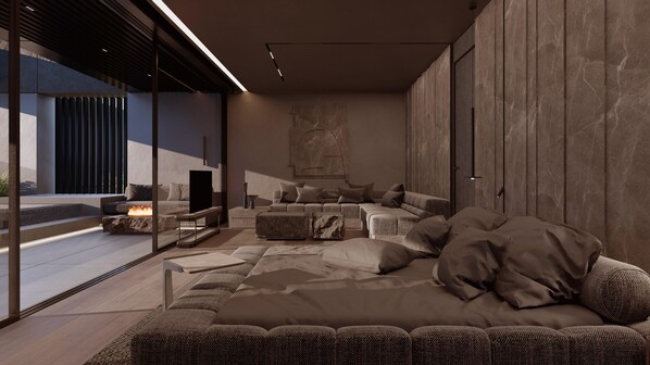 A modern living room with a large sofa, a TV, and a fireplace. - NEMA Design Hotel & Spa - Small Luxury Hotels of the World (Hersonissos)