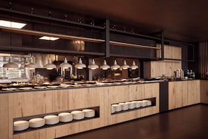 Una cocina moderna con armarios de madera, electrodomésticos de acero inoxidable e iluminación colgante.