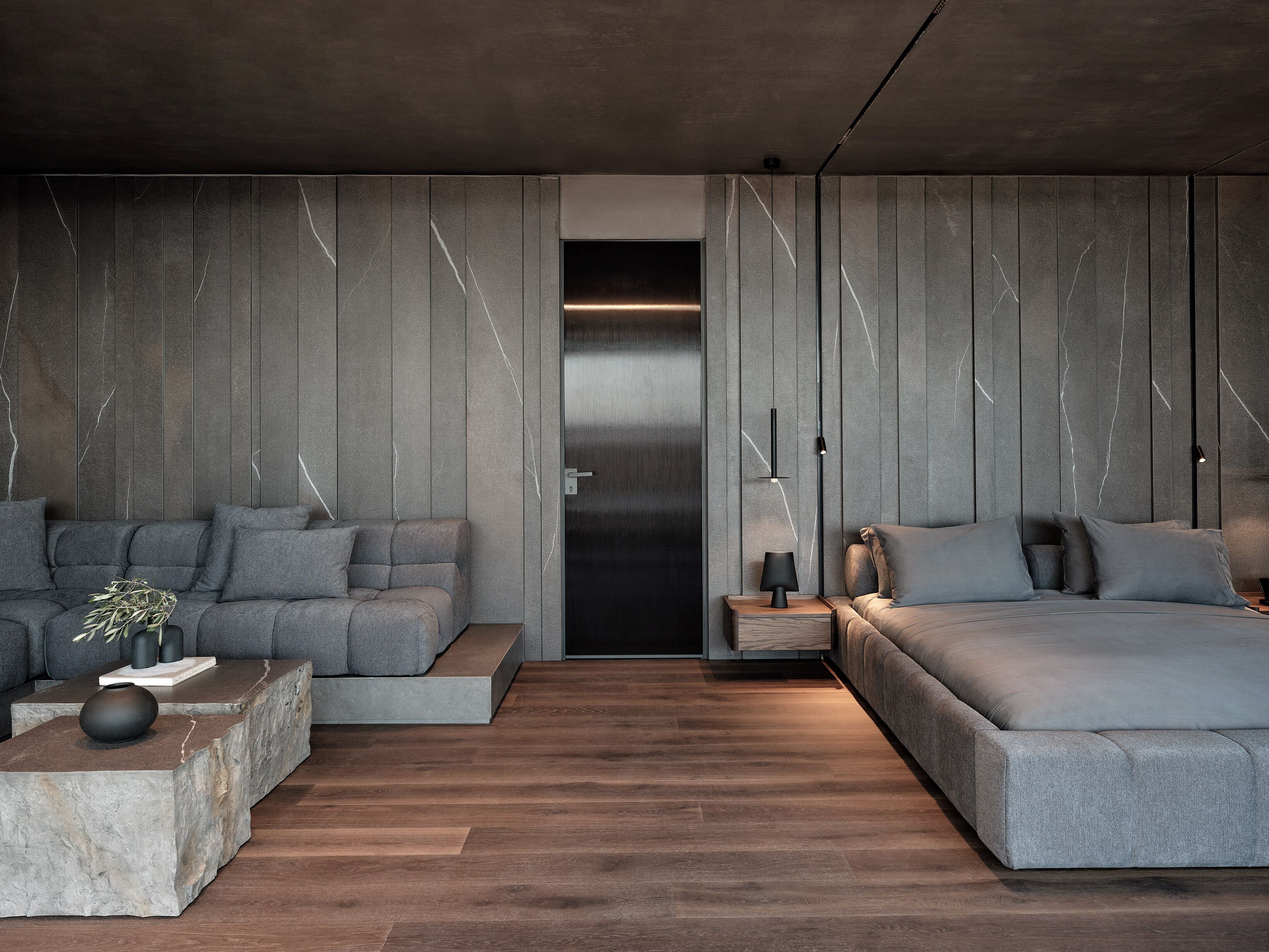 Una sala de estar moderna con un sofá, una mesa de centro y una cama.