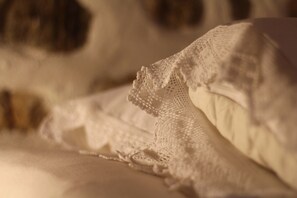 A close-up of a textured fabric, possibly a bedspread or blanket, with a lace pattern. - Efipoi (South Pelion)