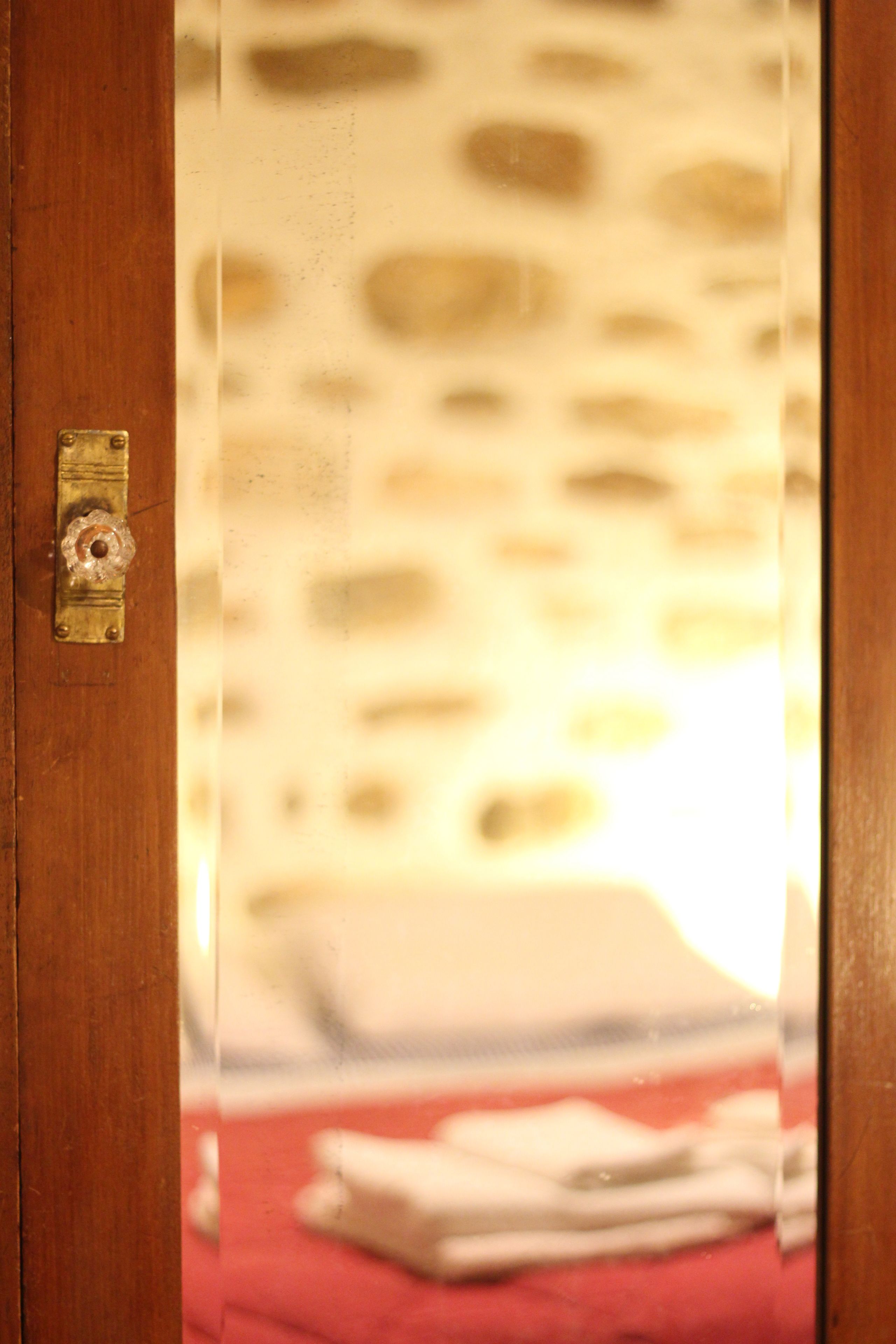 A wooden door with a brass handle and a keyhole.
