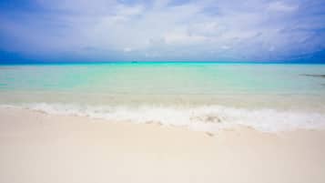 White sand, sun-loungers, beach umbrellas, beach towels