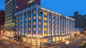 A multi-story hotel with a classic architectural style, featuring large windows and a corner location. - The Hi-Lo, Autograph Collection (Portland)