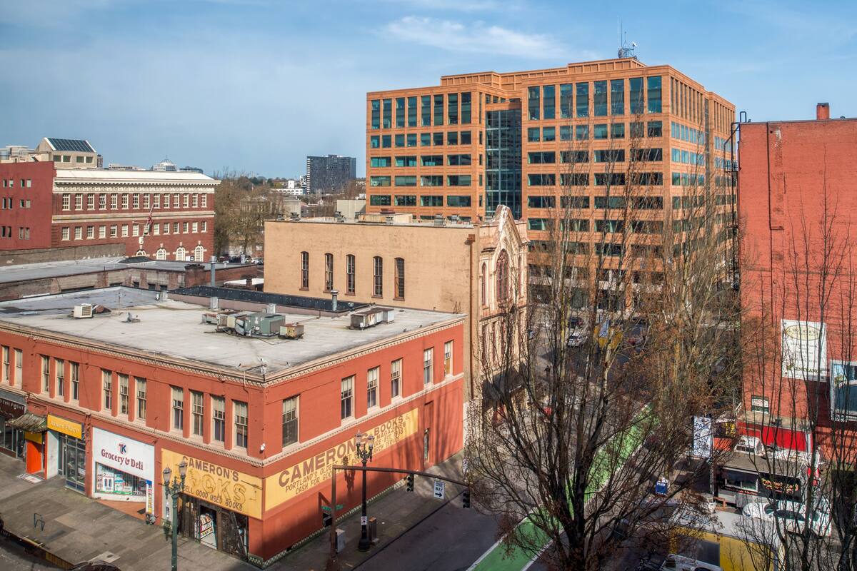 A multi-story building with a red brick facade and large windows.