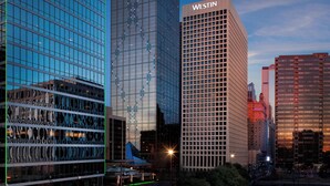 A cityscape with modern high-rise buildings, including a prominent building with "WESTIN" signage. - The Westin Dallas Downtown (Dallas)