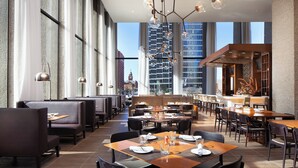 A modern restaurant with high ceilings, large windows, and a central bar area. - The Westin Dallas Downtown (Dallas)