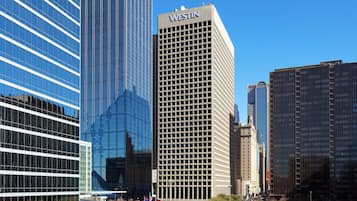 A modern cityscape with high-rise buildings, including a prominent building labeled "WESTIN".