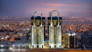 Located in the heart of the city, the Kempinski Hotel features two striking towers with the hotel's name prominently displayed.