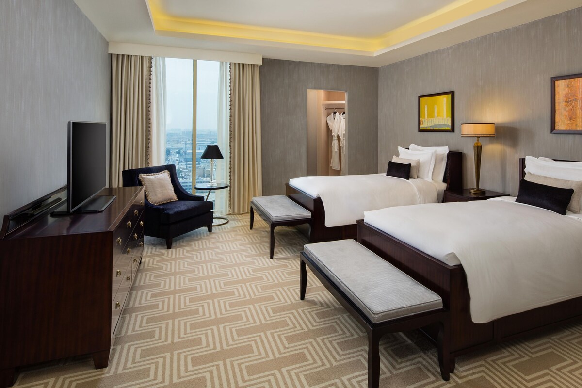 Kempinski, Family Apartment, 3 Twin Beds, City View | Minibar (free items), in-room safe, desk, laptop workspace