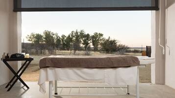 Enjoy a peaceful retreat with a single bed under a large window offering a view of the surrounding landscape.