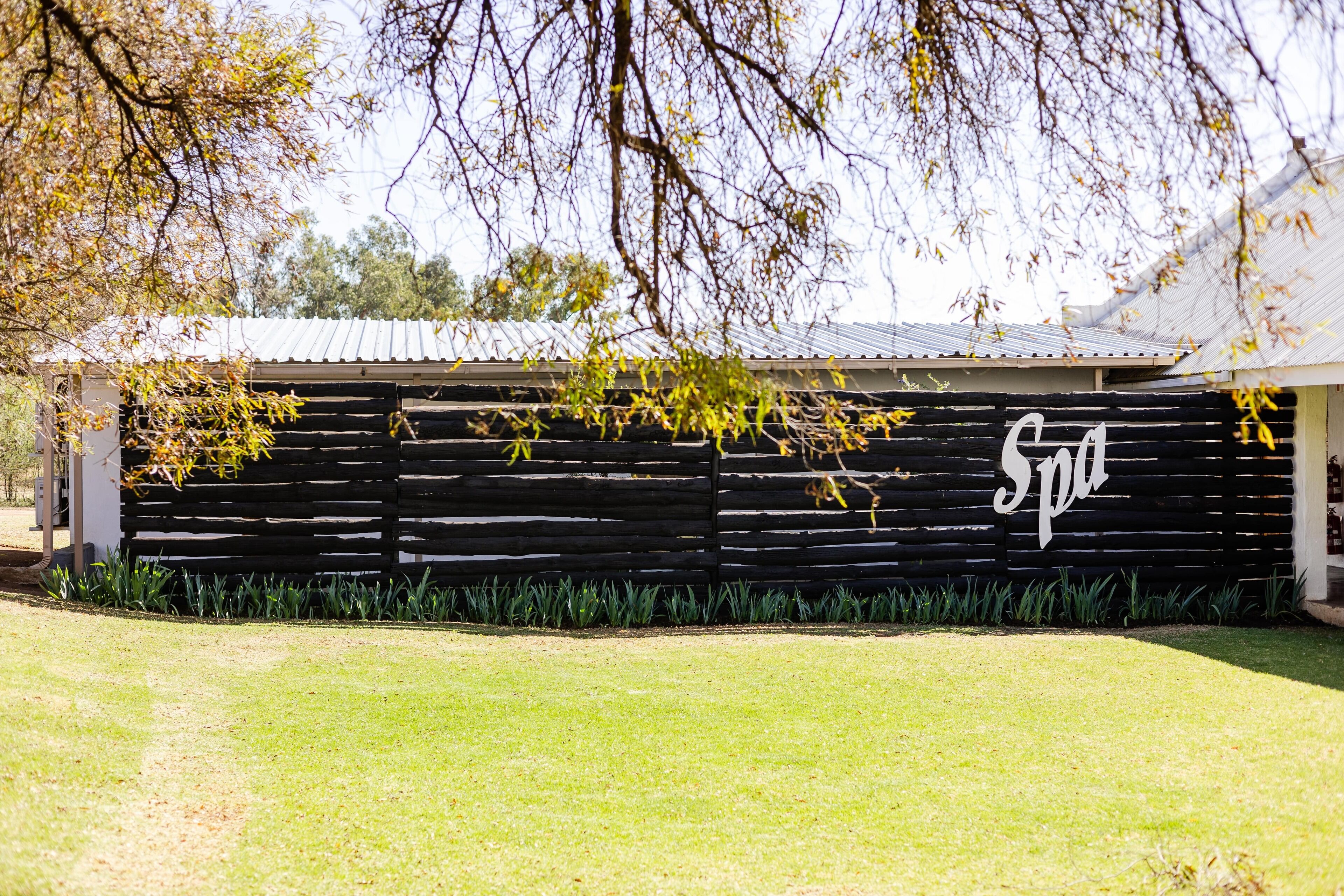 A building with a black exterior and a white sign that reads "Spa".