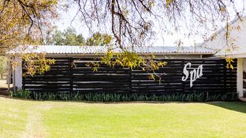 A building with a black exterior and a white sign that reads "Spa".
