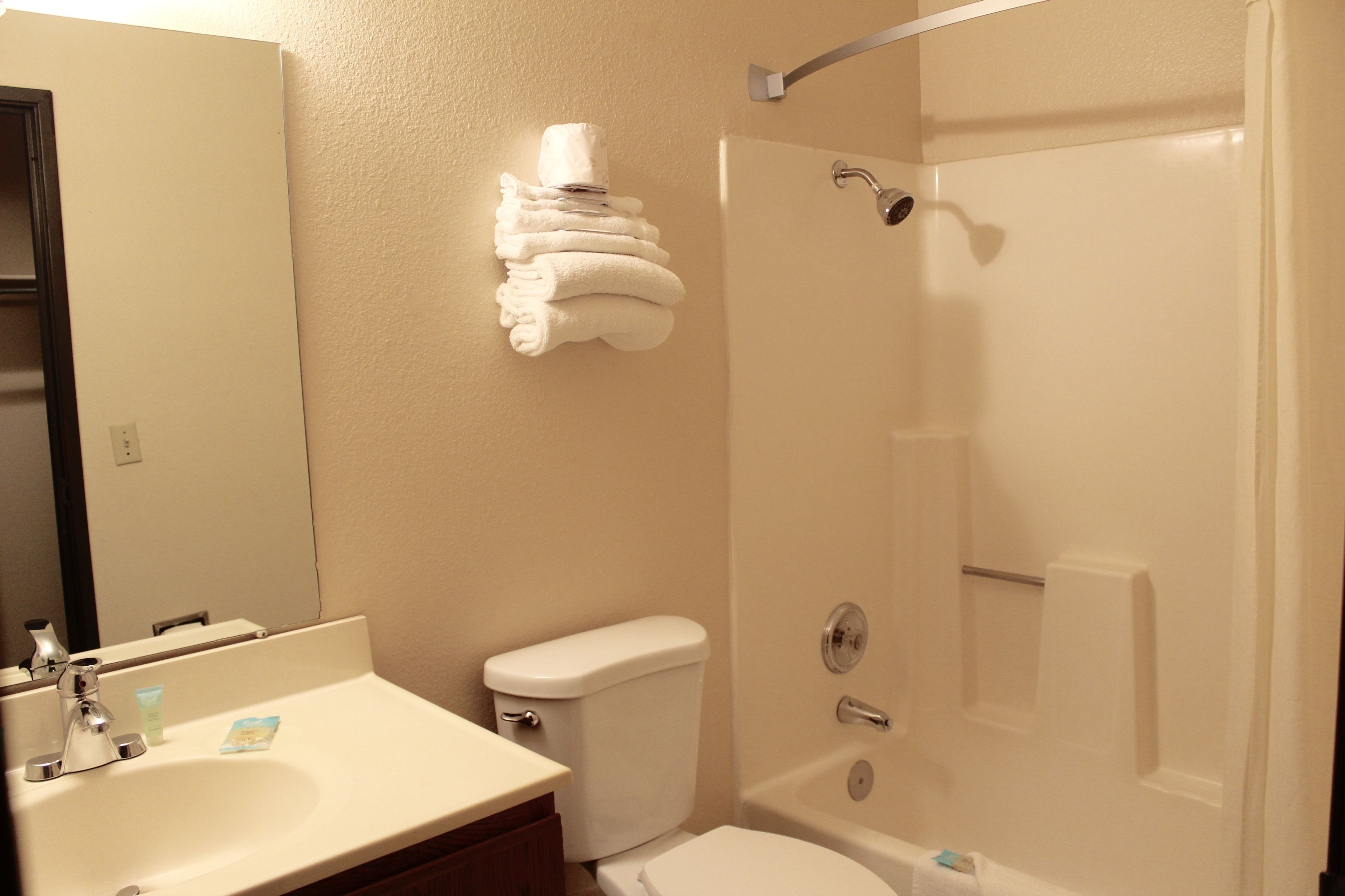 A bathroom with a sink, toilet, and shower.