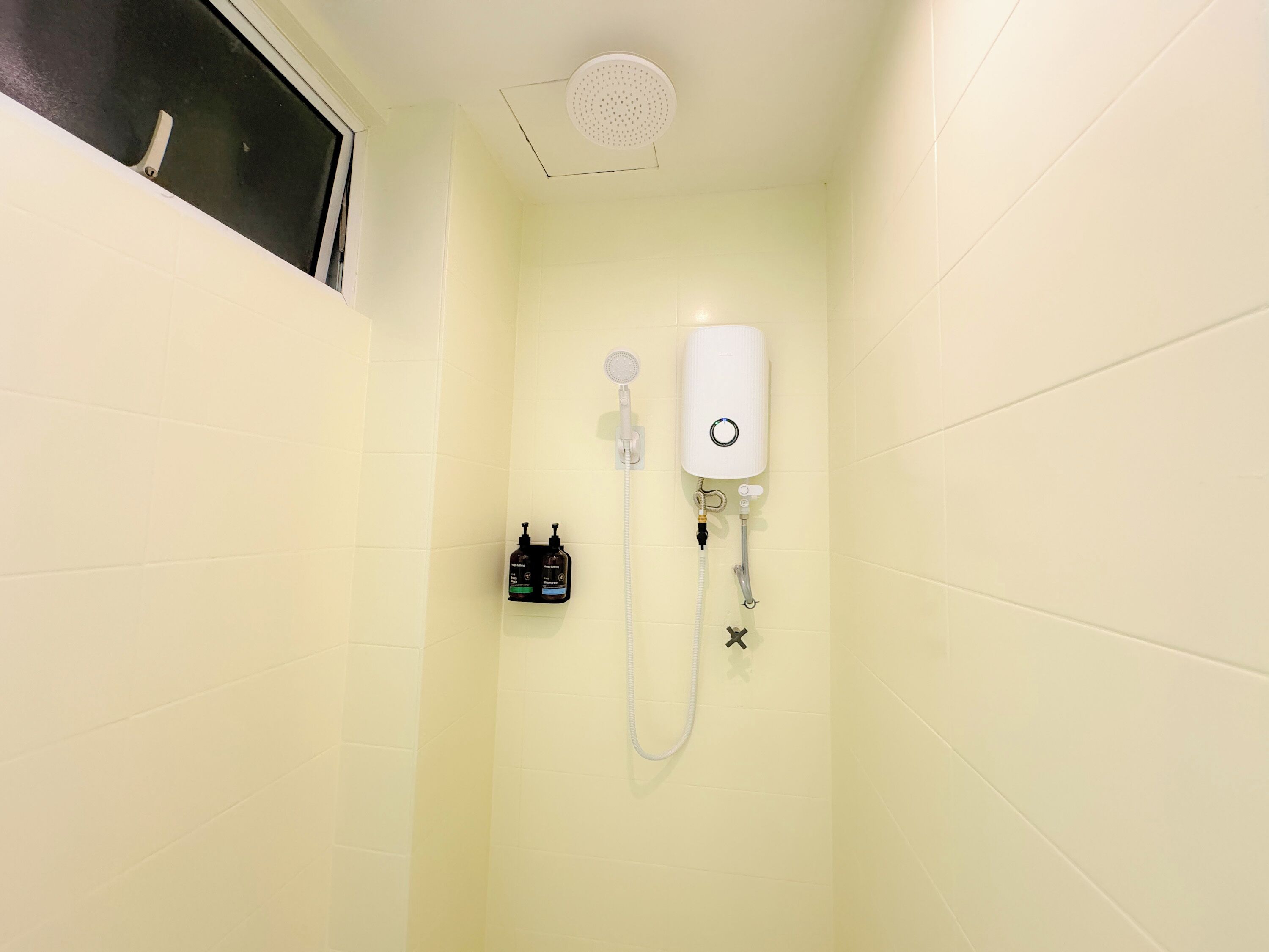 A bathroom with a shower, a toilet, and a sink.