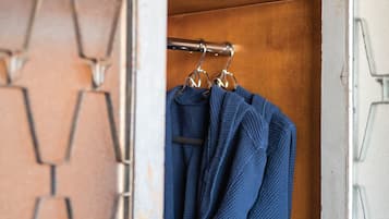 A closet with a wooden interior and a geometric patterned wall.
