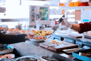 Una mesa de buffet con diferentes alimentos y utensilios.