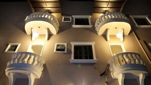 A building facade with symmetrical architectural features, including multiple balconies with railings and small windows. - Hotel Ria (Johor Bahru)