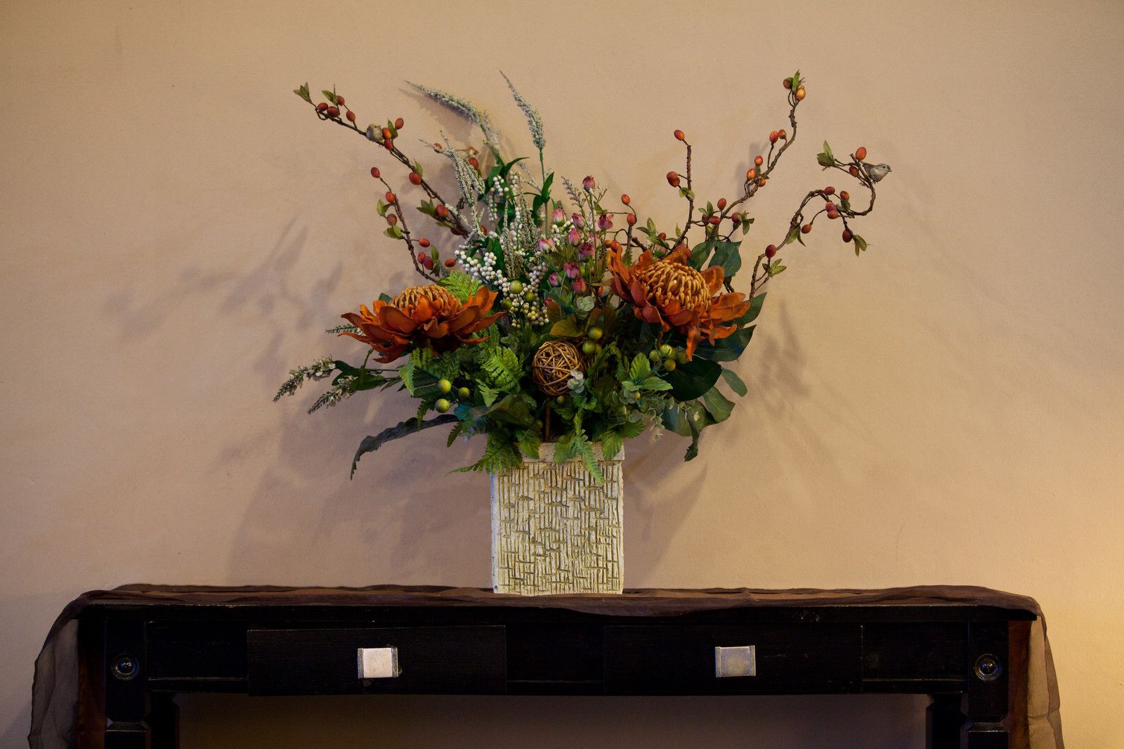 A vase with a floral arrangement on a table.