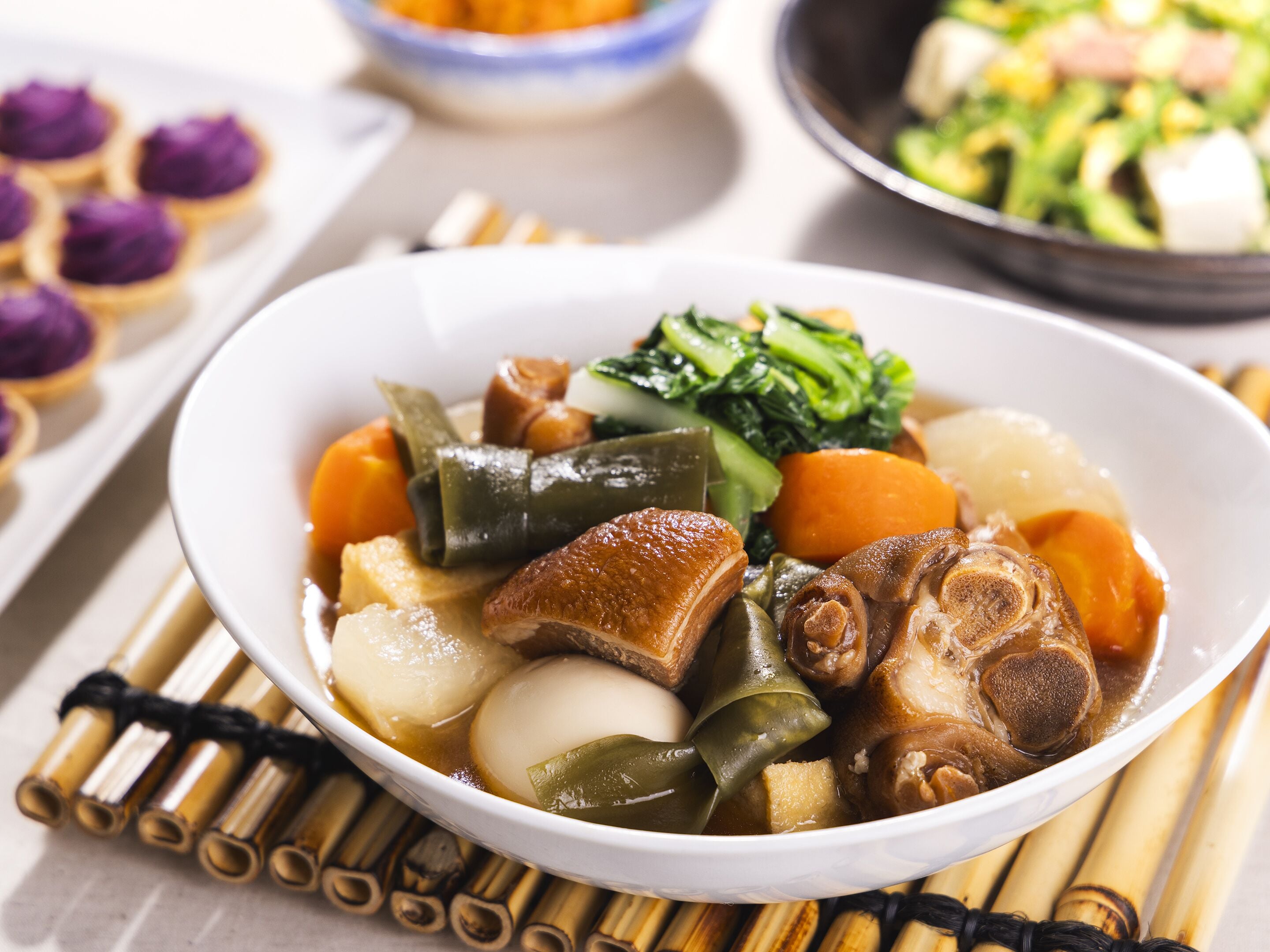 A bowl of Asian cuisine with various vegetables and tofu.
