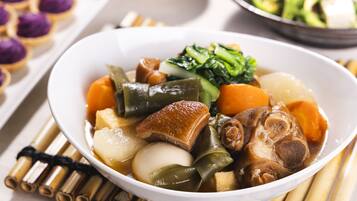 A bowl of Asian cuisine with various vegetables and tofu.
