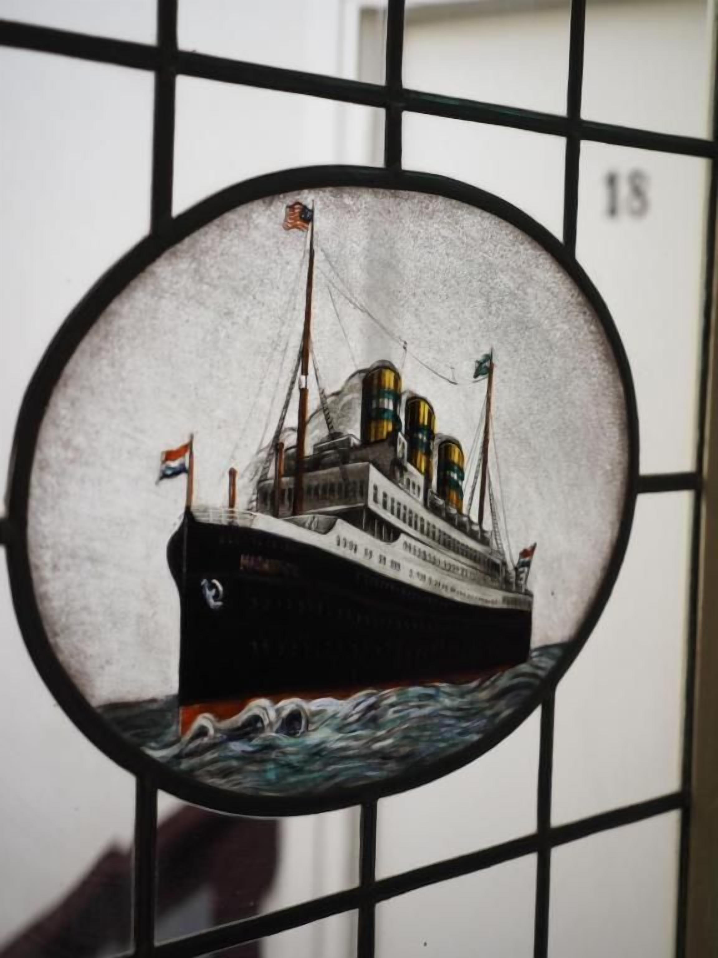 A circular window with a ship illustration.