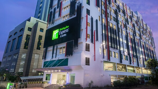 A Holiday Inn Express & Suites hotel with a modern design, featuring a prominent sign and a well-lit entrance. - Holiday Inn Express & Suites Johor Bahru by IHG (Johor Bahru)