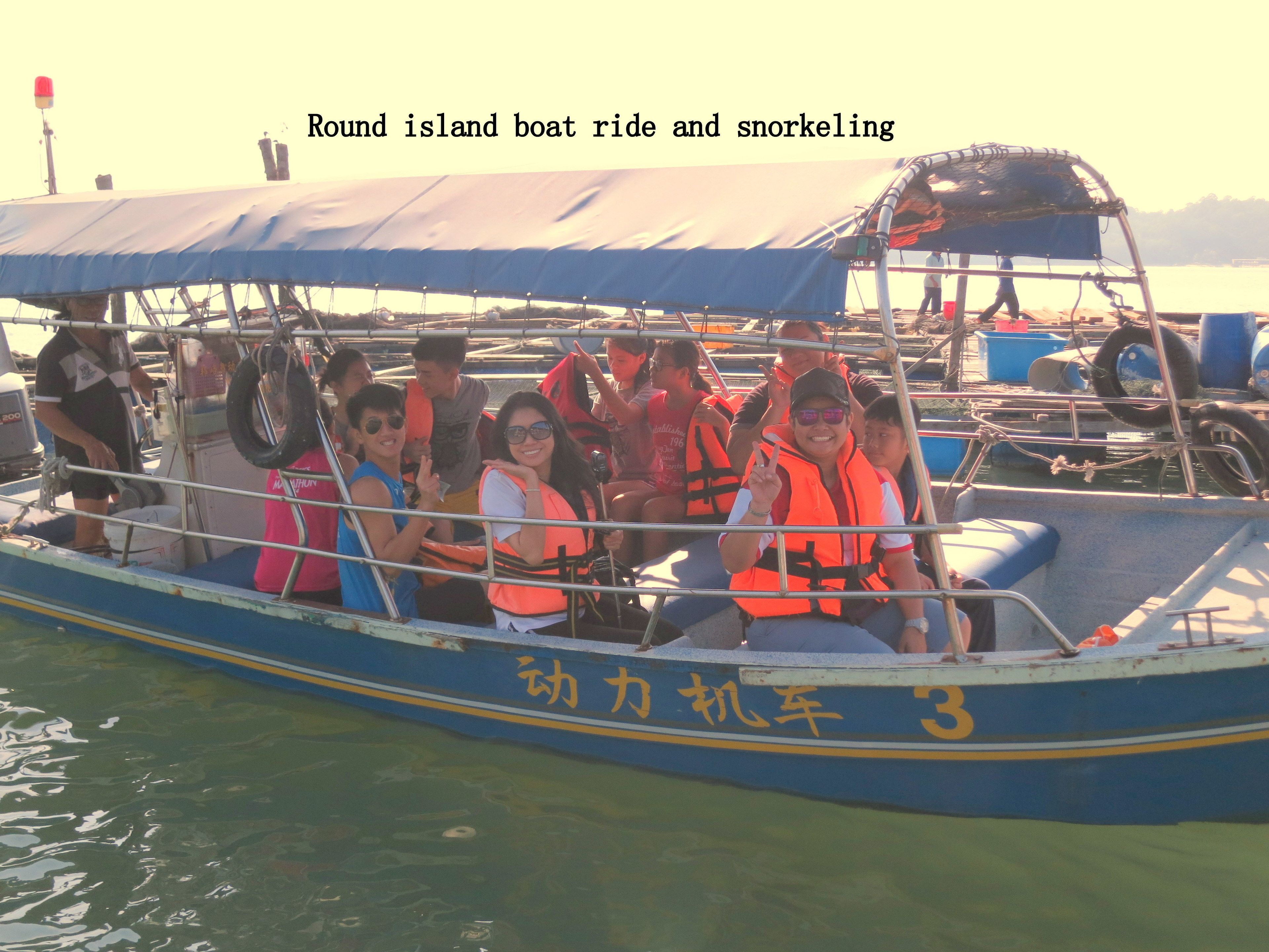 A boat with passengers wearing life jackets.