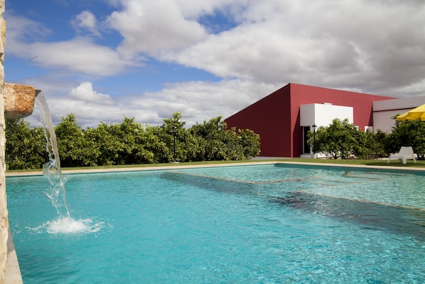 Outdoor pool, a waterfall pool, pool loungers