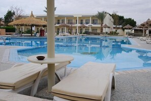 Piscina externa, guarda-sóis, espreguiçadeiras