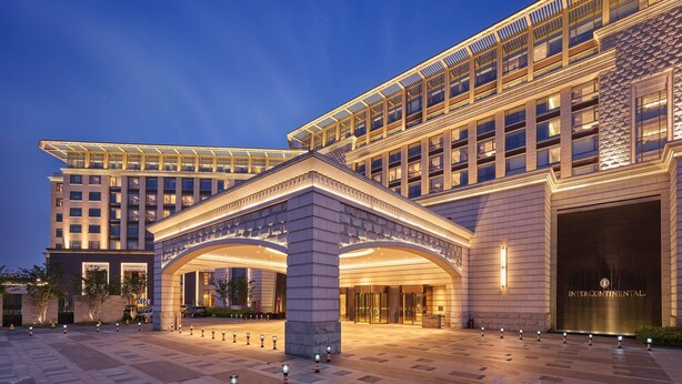 A modern hotel with a grand entrance, multiple floors, and a well-lit facade. - InterContinental Nantong by IHG (Nantong)