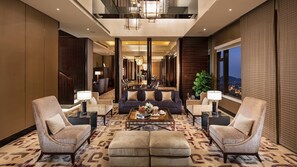 A spacious lobby with a sofa, two armchairs, a coffee table, and a dining area in the background. - InterContinental Nantong by IHG (Nantong)
