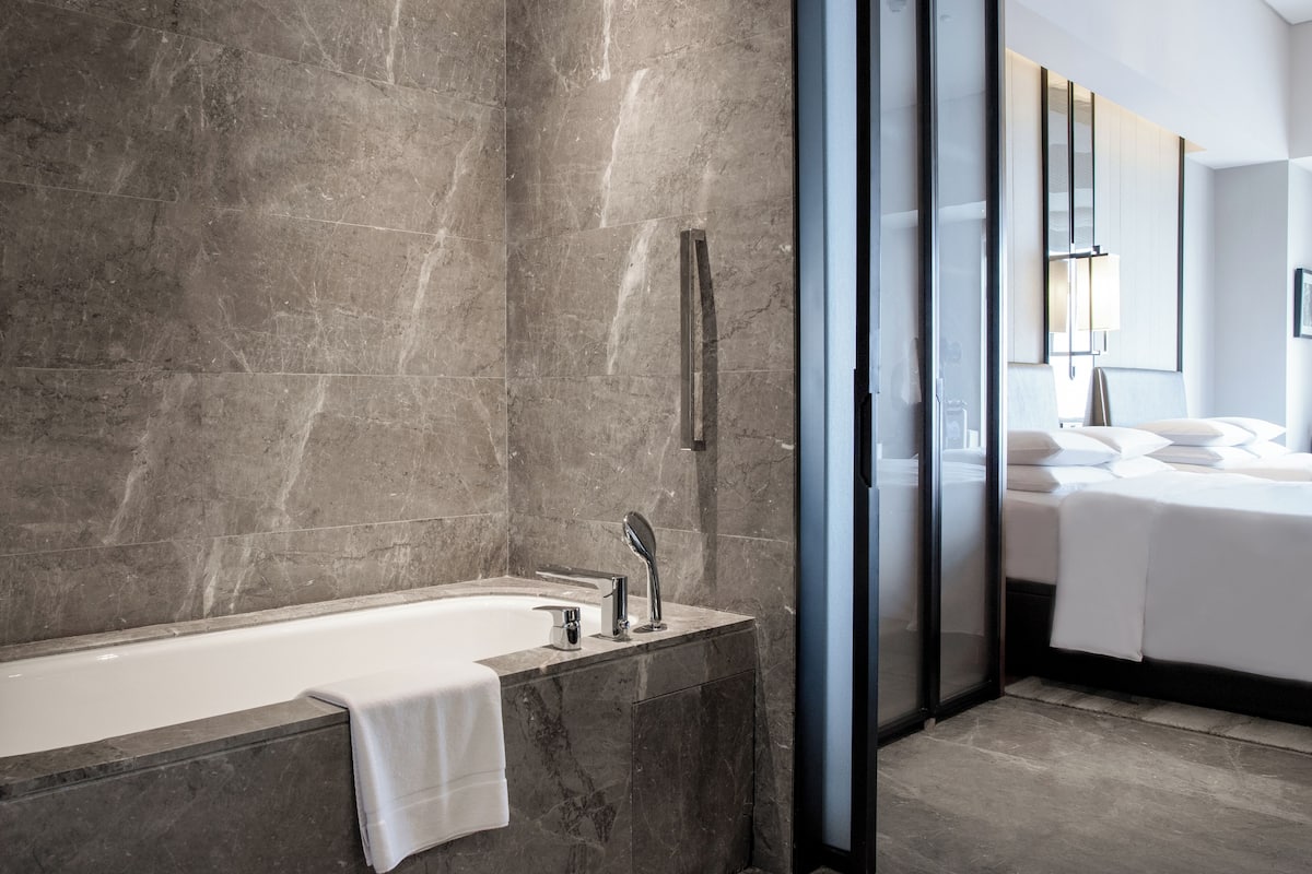 separate bathtub and shower, deep-soaking bathtub, designer toiletries